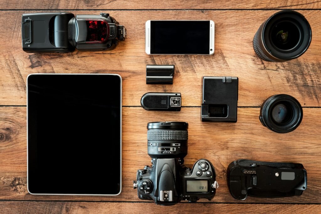 Photo equipment. Top view of diverse personal equipment for photographer laying on the wooden grain